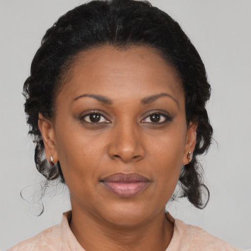Joyful black adult female with medium  brown hair and brown eyes
