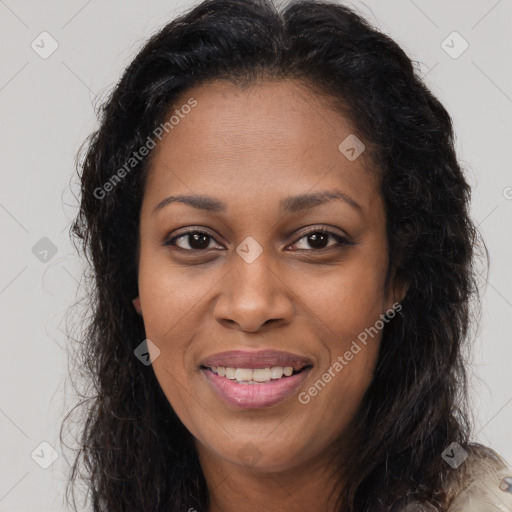 Joyful black young-adult female with long  brown hair and brown eyes