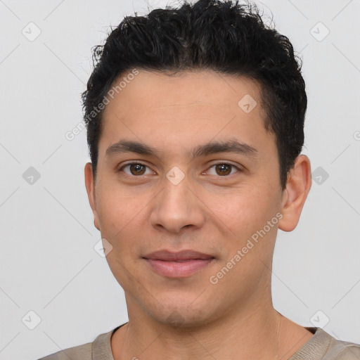 Joyful white young-adult male with short  black hair and brown eyes