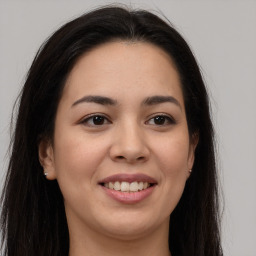 Joyful latino young-adult female with long  brown hair and brown eyes