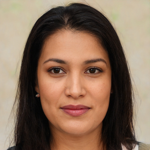 Joyful latino young-adult female with long  brown hair and brown eyes