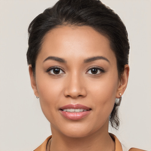 Joyful latino young-adult female with long  brown hair and brown eyes