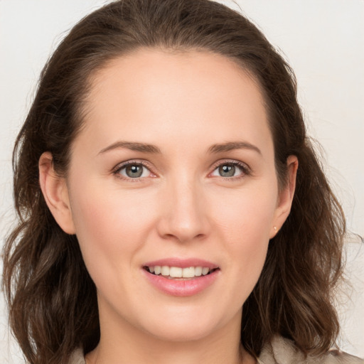 Joyful white young-adult female with long  brown hair and grey eyes