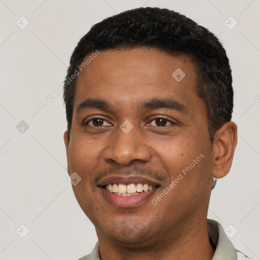 Joyful latino young-adult male with short  black hair and brown eyes