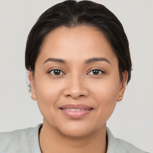 Joyful latino young-adult female with short  brown hair and brown eyes