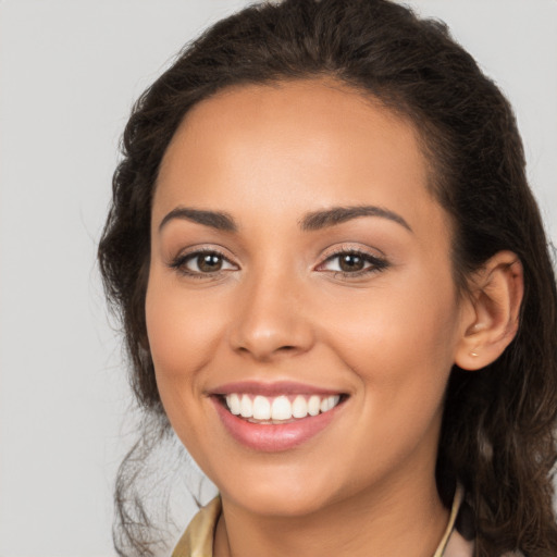 Joyful latino young-adult female with long  brown hair and brown eyes