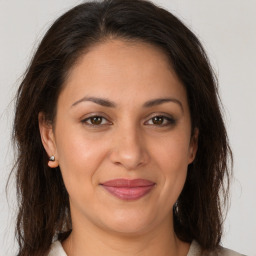 Joyful white adult female with long  brown hair and brown eyes