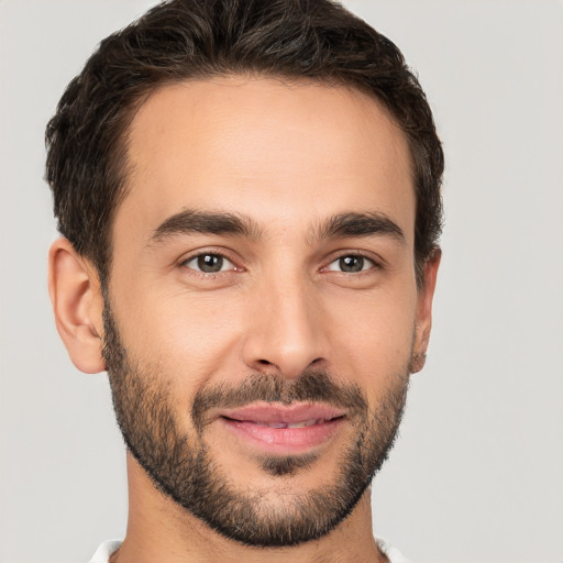 Joyful white young-adult male with short  brown hair and brown eyes