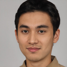 Joyful asian young-adult male with short  black hair and brown eyes