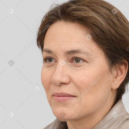 Joyful white adult female with medium  brown hair and brown eyes