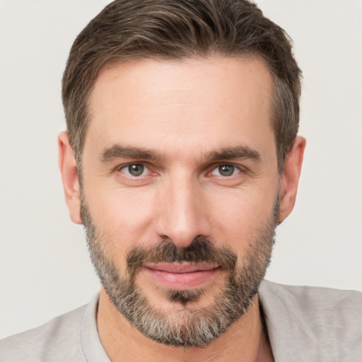 Joyful white adult male with short  brown hair and brown eyes