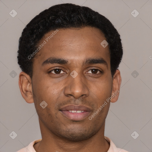 Joyful black young-adult male with short  black hair and brown eyes