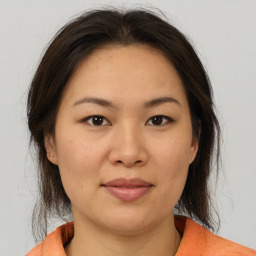 Joyful asian young-adult female with medium  brown hair and brown eyes