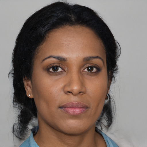 Joyful black young-adult female with medium  brown hair and brown eyes