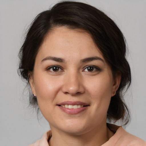 Joyful white young-adult female with medium  brown hair and brown eyes