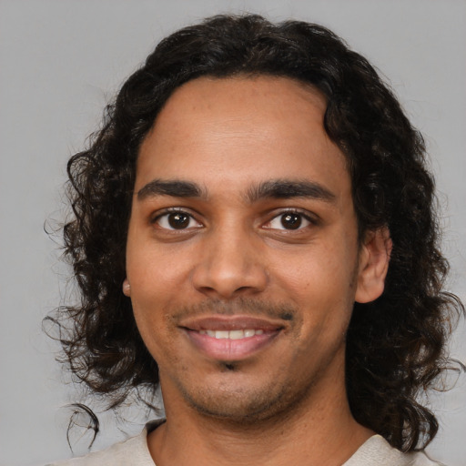 Joyful latino young-adult male with medium  black hair and brown eyes