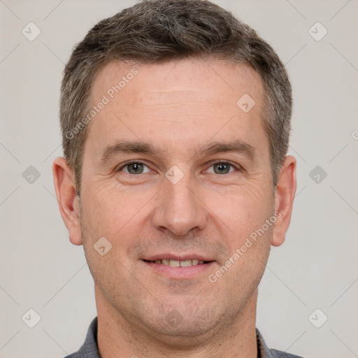 Joyful white adult male with short  brown hair and brown eyes