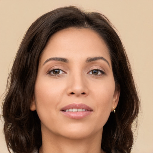 Joyful white young-adult female with long  brown hair and brown eyes