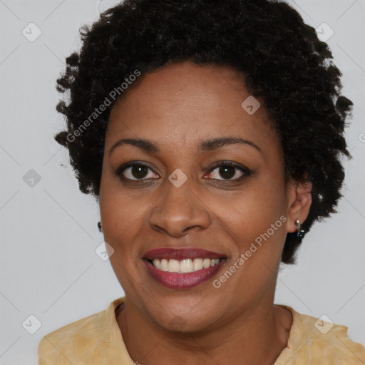 Joyful black adult female with short  brown hair and brown eyes