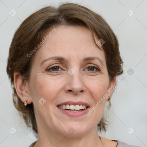 Joyful white adult female with medium  brown hair and grey eyes