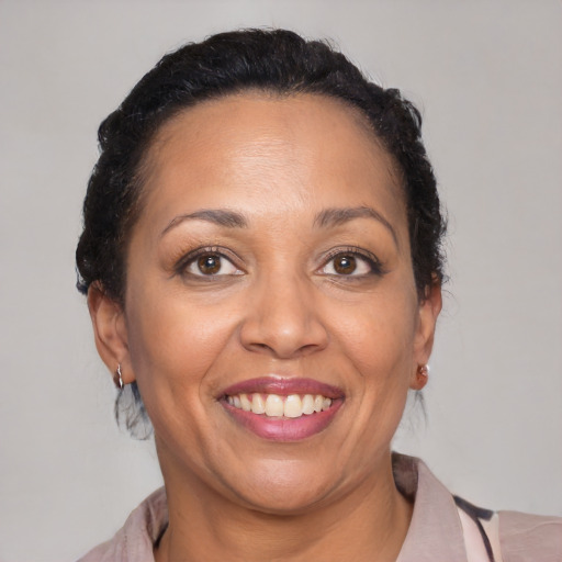 Joyful latino adult female with medium  brown hair and brown eyes
