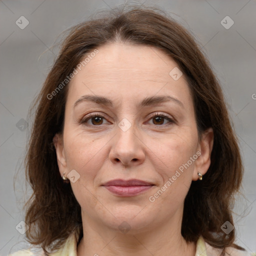 Joyful white adult female with medium  brown hair and brown eyes