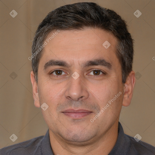 Joyful white adult male with short  brown hair and brown eyes