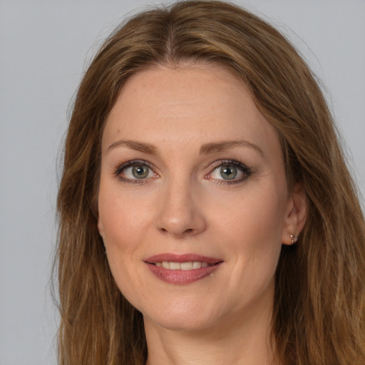 Joyful white young-adult female with long  brown hair and grey eyes