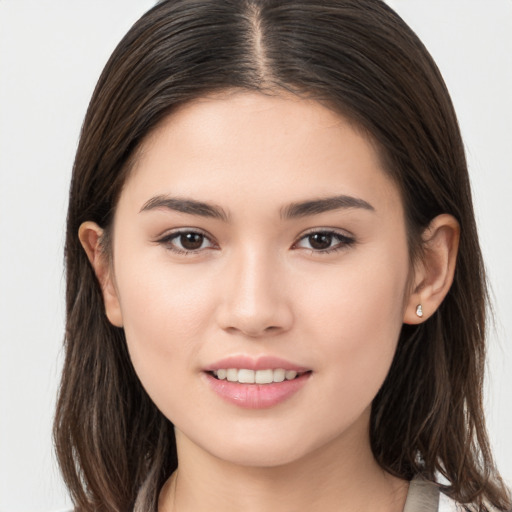 Joyful white young-adult female with long  brown hair and brown eyes