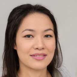 Joyful asian young-adult female with long  brown hair and brown eyes