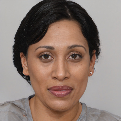 Joyful asian adult female with medium  brown hair and brown eyes