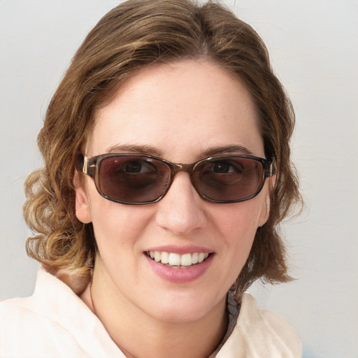 Joyful white young-adult female with medium  brown hair and blue eyes