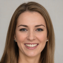 Joyful white young-adult female with long  brown hair and grey eyes