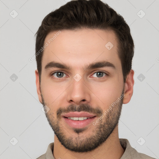 Joyful white young-adult male with short  brown hair and brown eyes