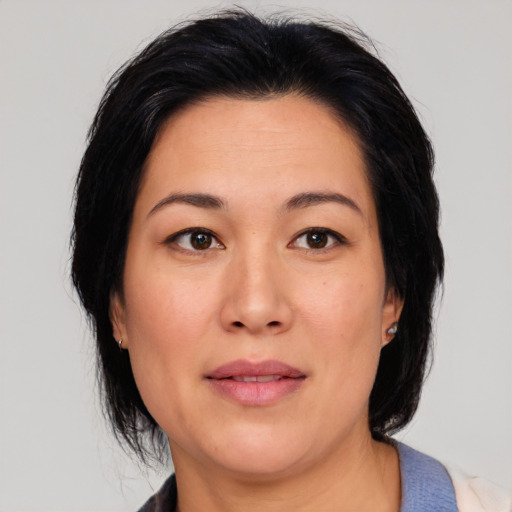 Joyful asian young-adult female with medium  black hair and brown eyes