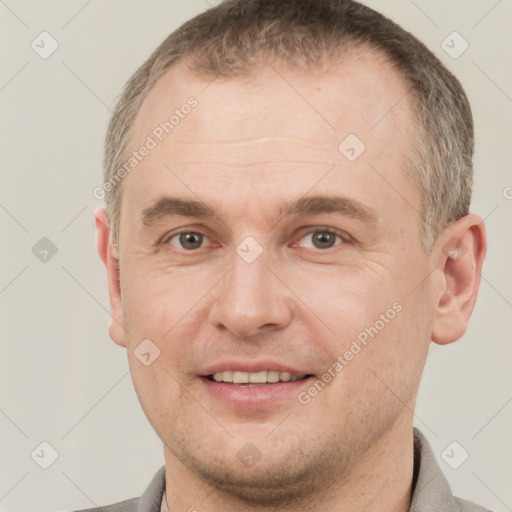 Joyful white adult male with short  brown hair and grey eyes