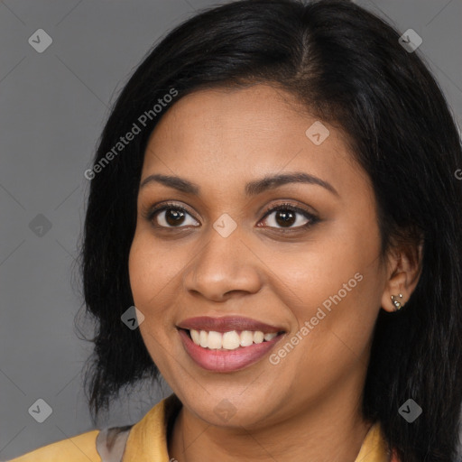 Joyful black young-adult female with long  brown hair and brown eyes