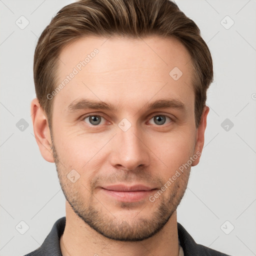 Joyful white young-adult male with short  brown hair and grey eyes