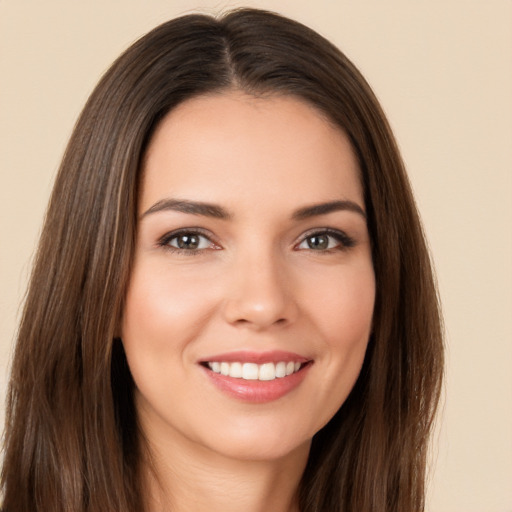 Joyful white young-adult female with long  brown hair and brown eyes