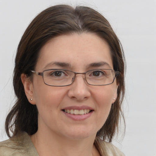 Joyful white adult female with medium  brown hair and brown eyes