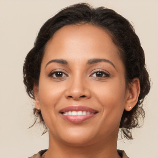 Joyful latino young-adult female with medium  brown hair and brown eyes