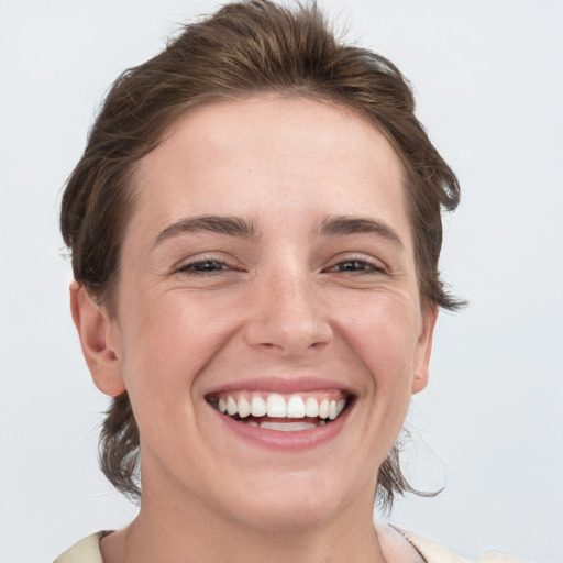 Joyful white young-adult female with medium  brown hair and grey eyes