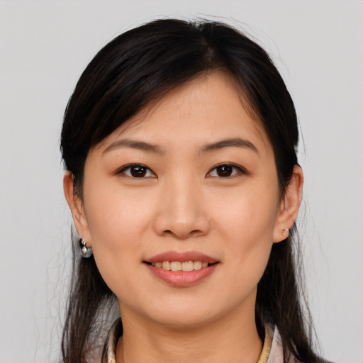 Joyful asian young-adult female with medium  brown hair and brown eyes