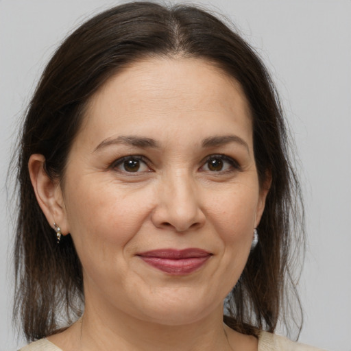 Joyful white adult female with medium  brown hair and brown eyes