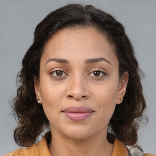 Joyful black young-adult female with medium  brown hair and brown eyes