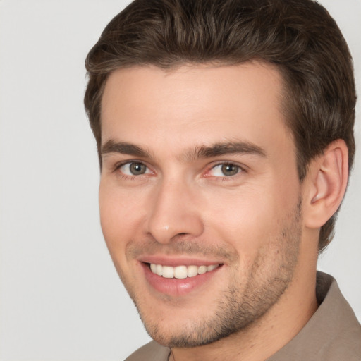 Joyful white young-adult male with short  brown hair and brown eyes