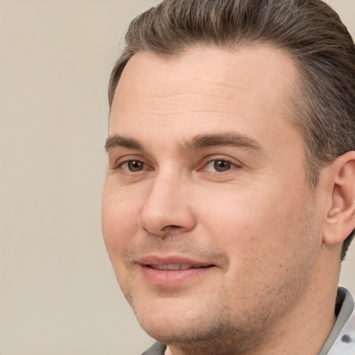 Joyful white young-adult male with short  brown hair and brown eyes