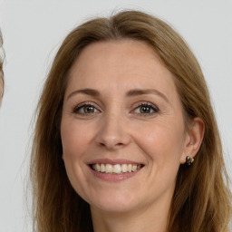 Joyful white adult female with long  brown hair and grey eyes