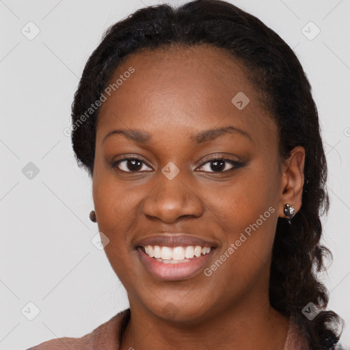 Joyful black young-adult female with long  brown hair and brown eyes