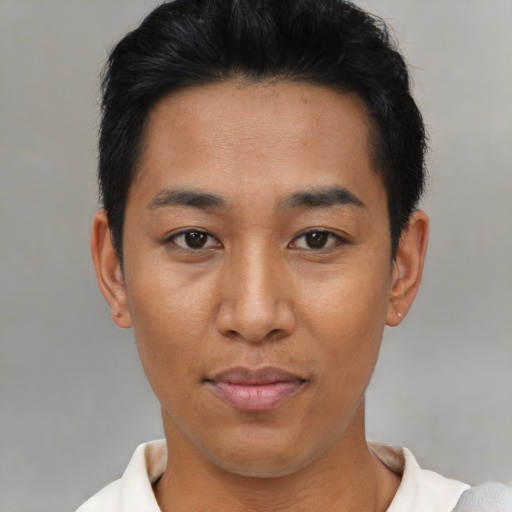 Joyful black young-adult male with short  brown hair and brown eyes